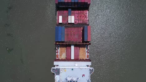 top down aerial view of the stern and bridge of a large container ship on a sunny day