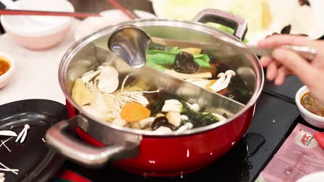 preparing hotpot with fresh ingredients in bangkok