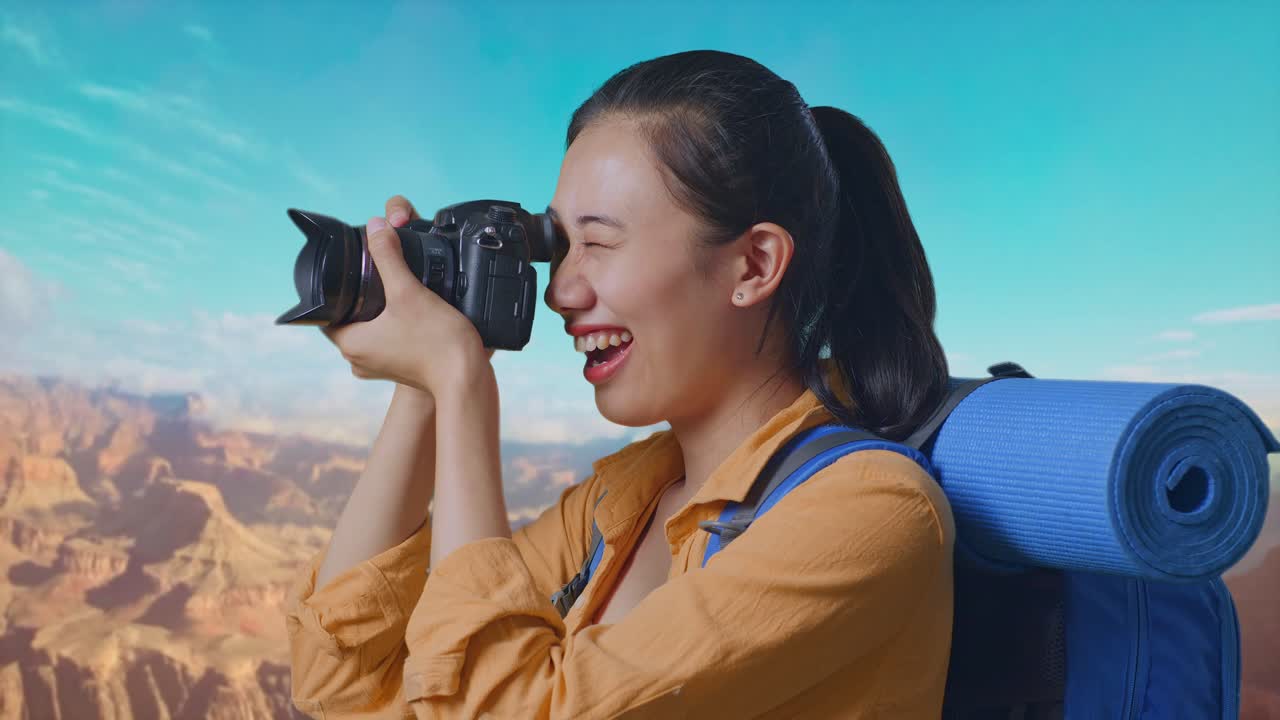 Close Up Side View Of Asian Female Hiker With Mountaineering Backpack Using A Camera Taking Picture While Traveling At The Top Of Mountain