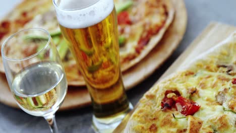 Delicious-pizza-with-a-glasses-of-beer-and-wine