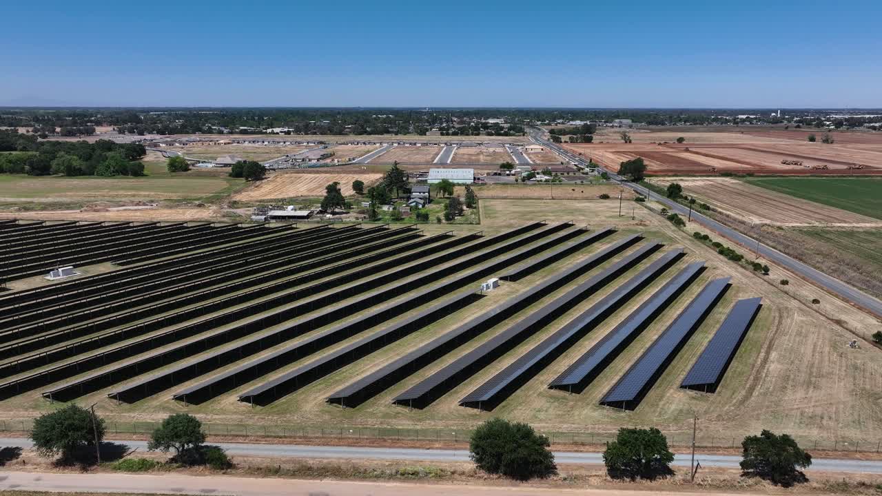 A solar farm in a rural area shot from the air with a drone.