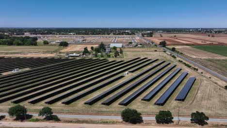 a solar farm in a rural area shot from the air with a drone.