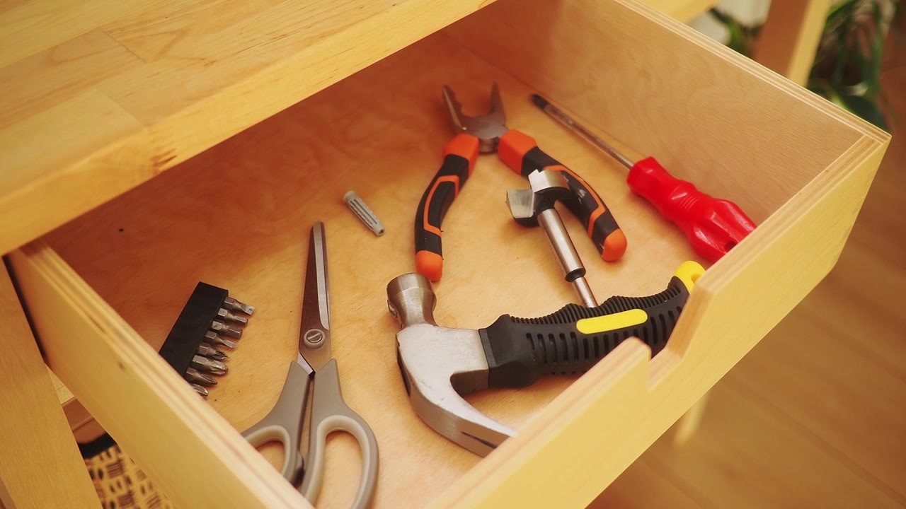 Assorted Hand Tools Organized in a Wooden Drawer