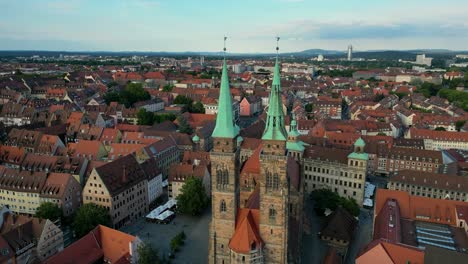 4k aerial drone video of sebalduskirche church with twin spiers in nurnberg, germany