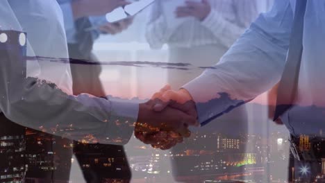 Animation-of-businessman-handshake-over-cityscape