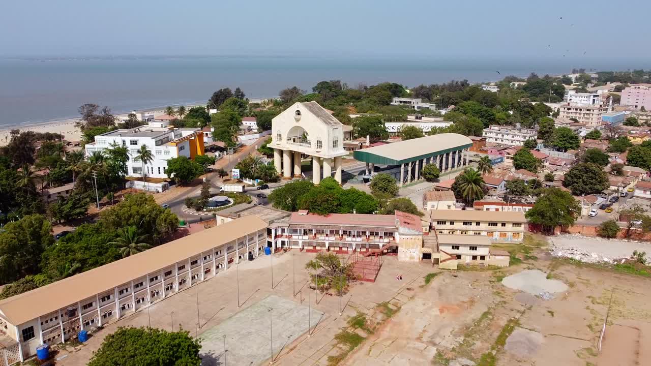 Drone view of Banjul flying over Gambia High School towards Arch 22