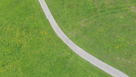 Aerial-of-a-Swiss-Grassy-Valley-with-a-Small-Village-and-Gondola