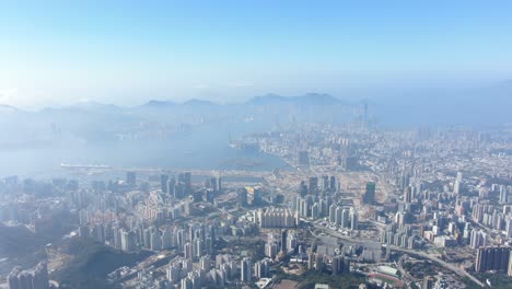 Hong-Kong-bay-and-skyline-with-skyscrapers,-high-altitude-wide-shot