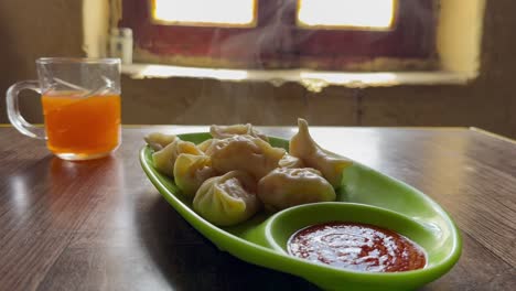hot steaming momos and seabuckthorn tea served at a cozy cafe in spiti valley
