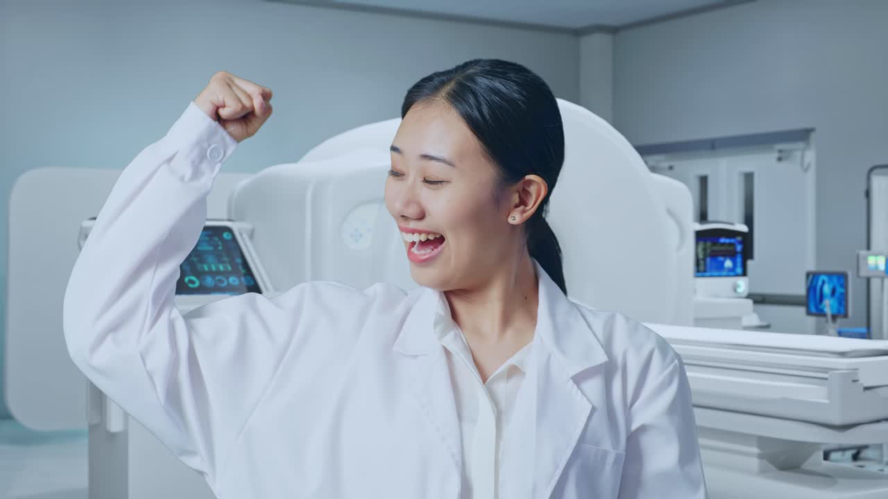 Close Up Of Asian Woman Doctor Smile And Flex Muscle With Mri Machine In The Hospital