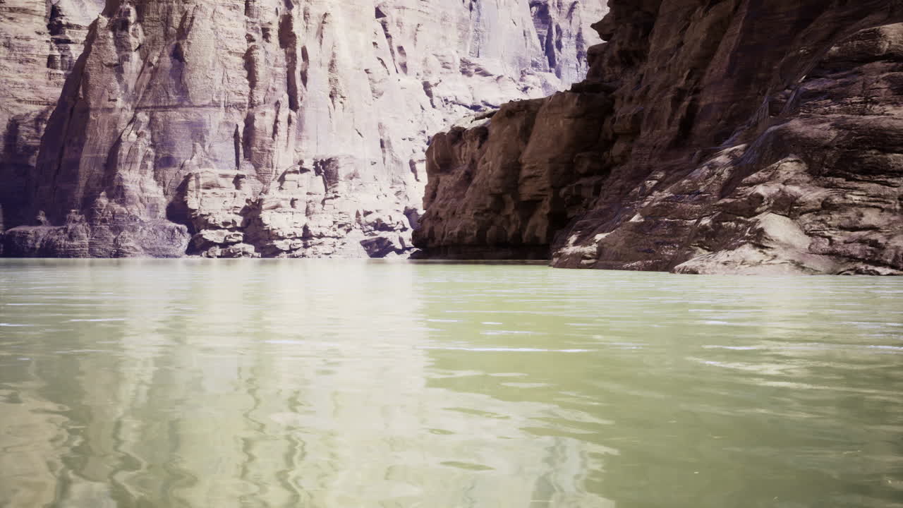 Serene river landscape with rocky cliffs and calm water reflections