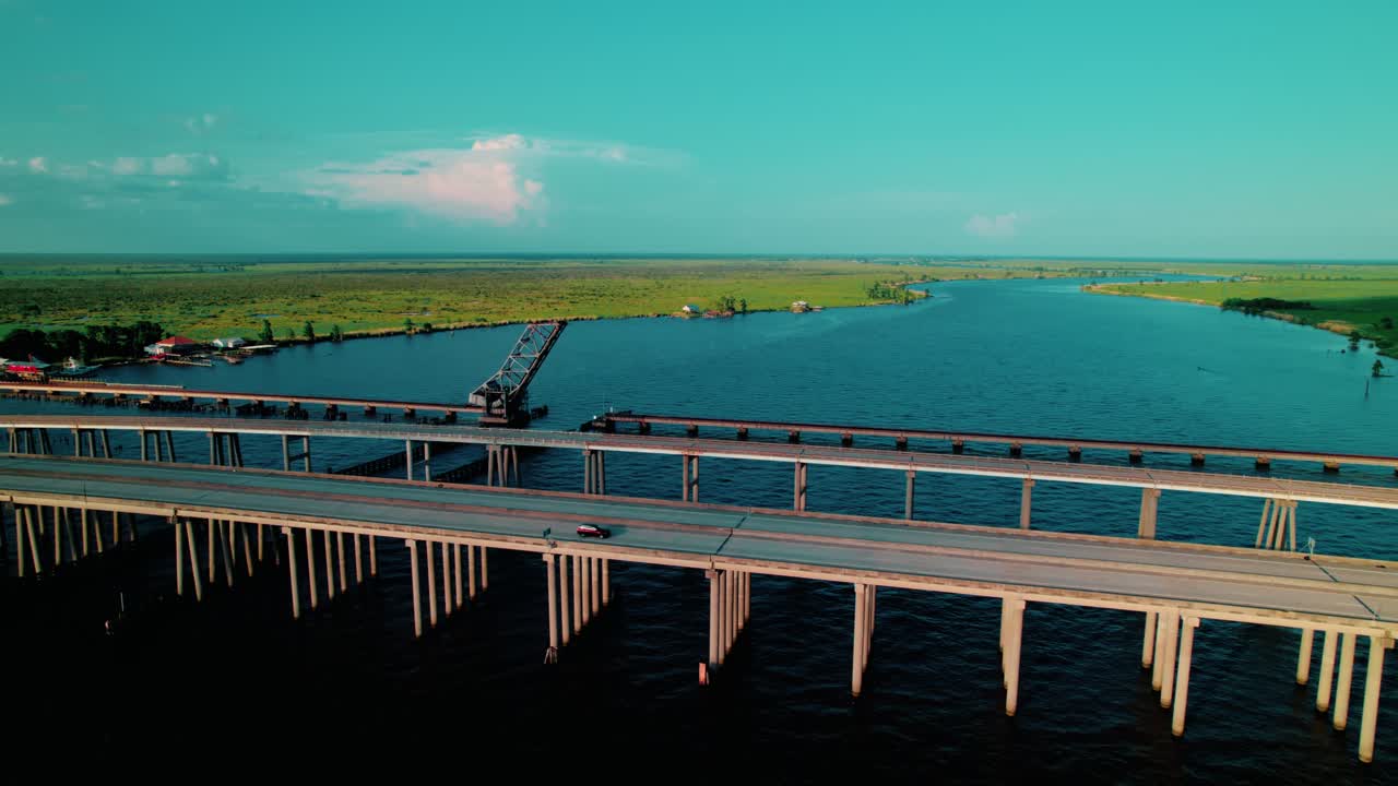 Aerial drone orbiting the Manchac Swamp Bridge over Louisiana’s Atchafalaya Basin, featuring an elevated causeway through serene cypress wetlands.