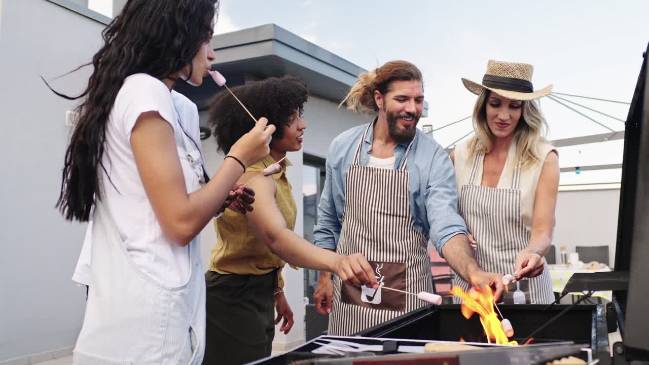 Group of friends grilling marshmallows outdoors