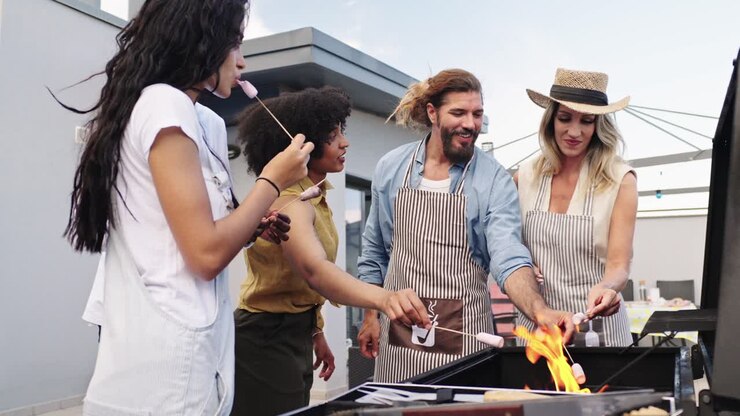 Group of friends grilling marshmallows outdoors