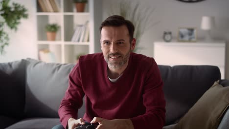 man playing video game at home