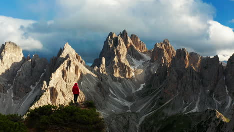 man views epic sunset over dolomites in italy