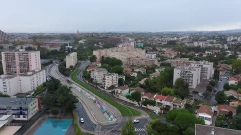 Montpellier-aerial-shot-tramway-and-flooded-river-cloudy-day-buildings-France