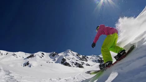 snowboarder carving powder in the mountains