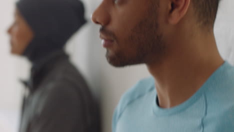 close up attractive hispanic man using smartphone in yoga studio browsing online sharing healthy lifestyle on social media enjoying mobile phone communication