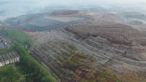 aerial view of a landfill with workers and machinery