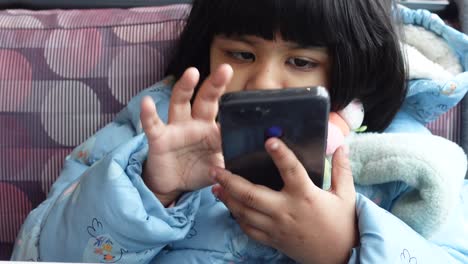 Child-girl-watching-cartoon-on-smart-phone-,