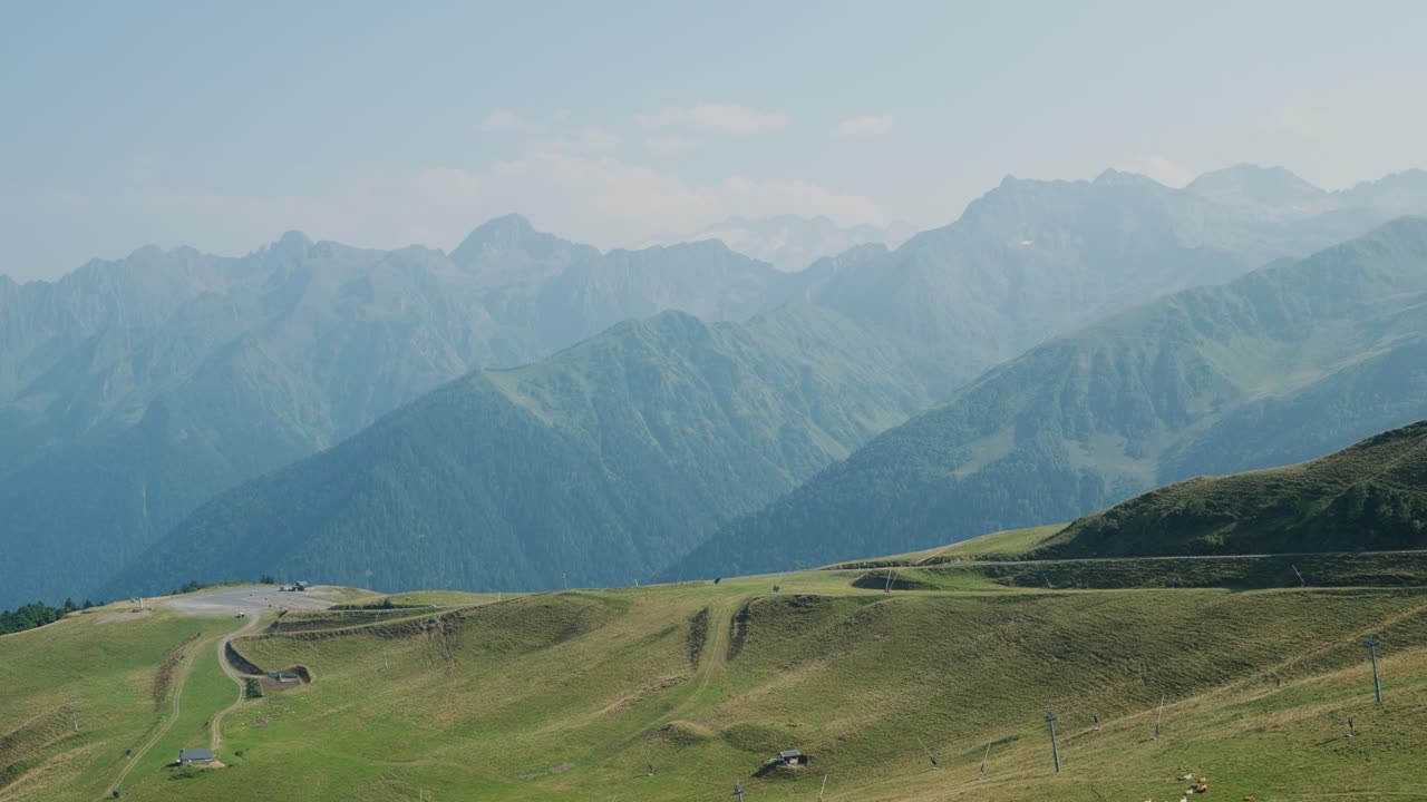 Panoramic View of Majestic Mountains and Green Hills