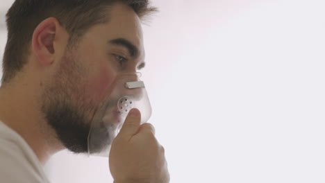 close up of a sick man breathing through oxygen mask 3