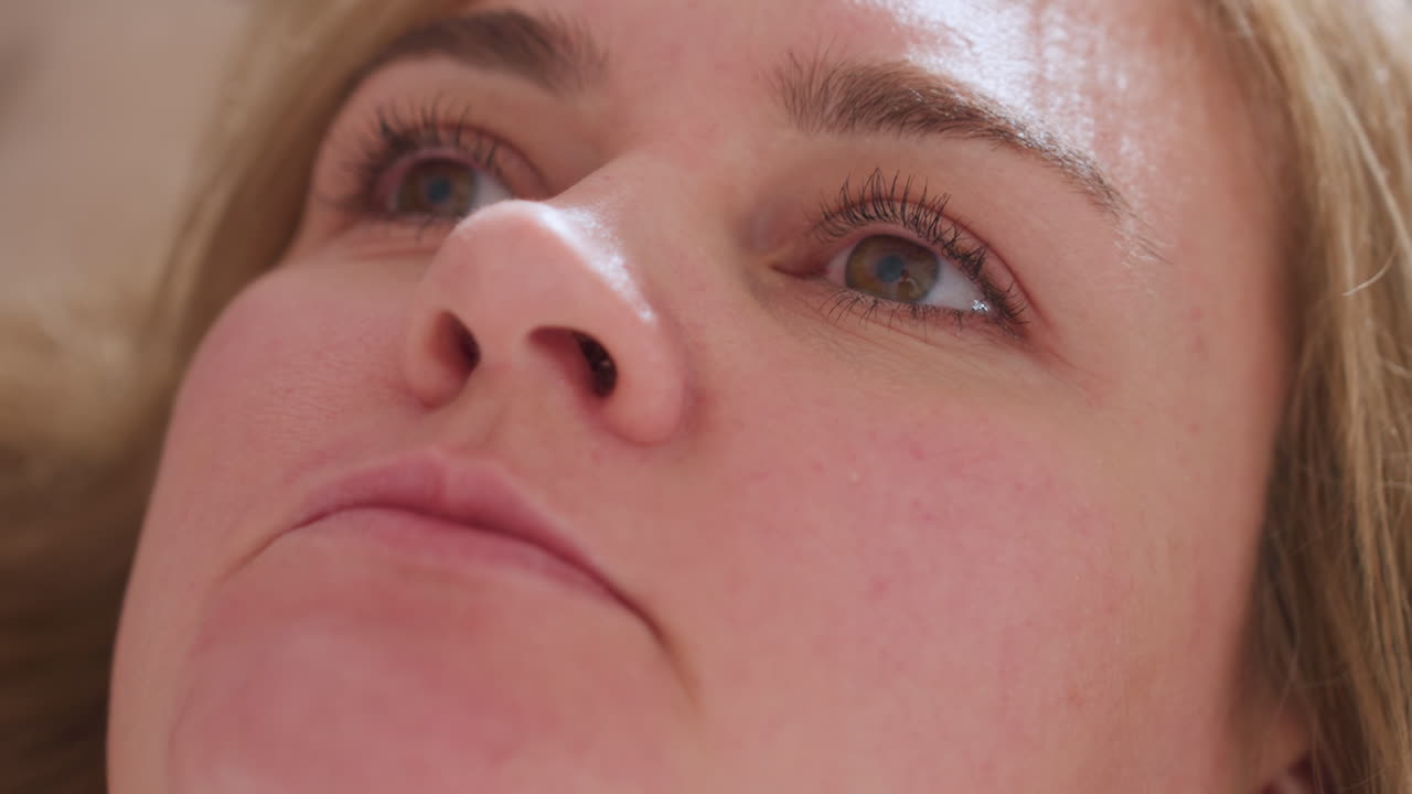 Mindful guest laying back on couch looking upward while speaking during therapeutic session expressing openness reflection and engagement with counselor in calm supportive wellness setting