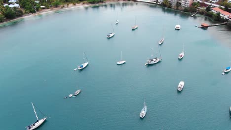 yachts anchored in tranquil pickly bay marina, grenada, with lush surroundings, aerial view