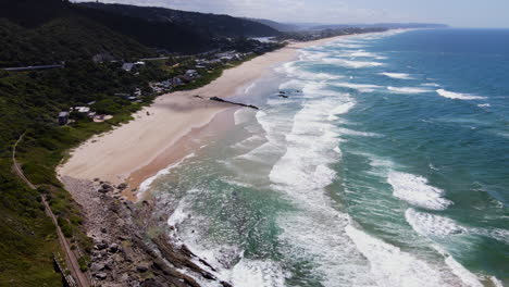 Beautiful-aerial-view-over-vast-white-sand-beach-in-Wilderness,-Garden-Route