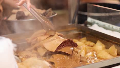 vendor cooking and serving traditional hong kong dish