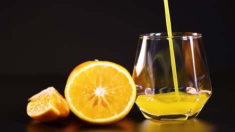 orange juice being poured into a glass