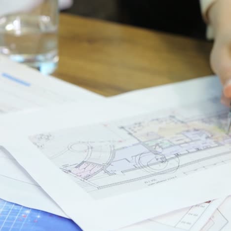 engineers discussing blueprint at meeting
