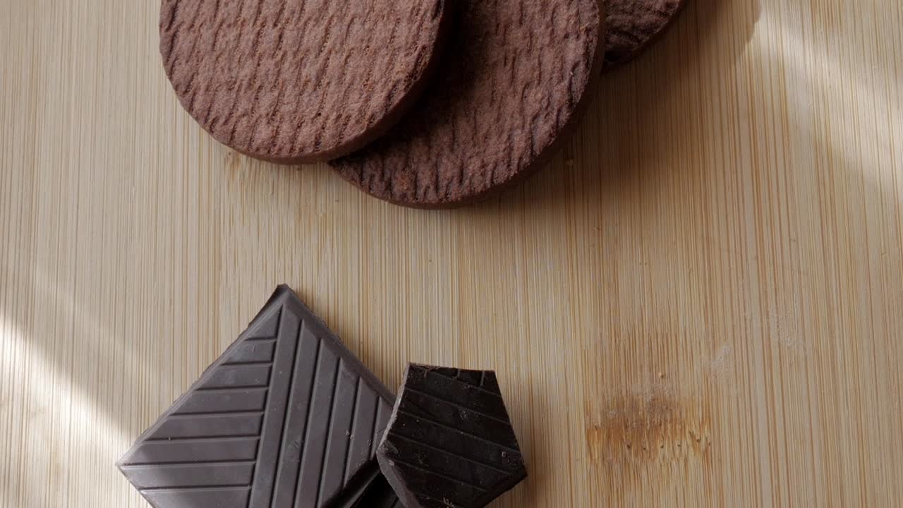 Chocolate biscuits placed on a wooden table, a close-up shot of the textured surface