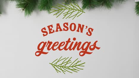 animation of seasons greetings text over christmas decorations