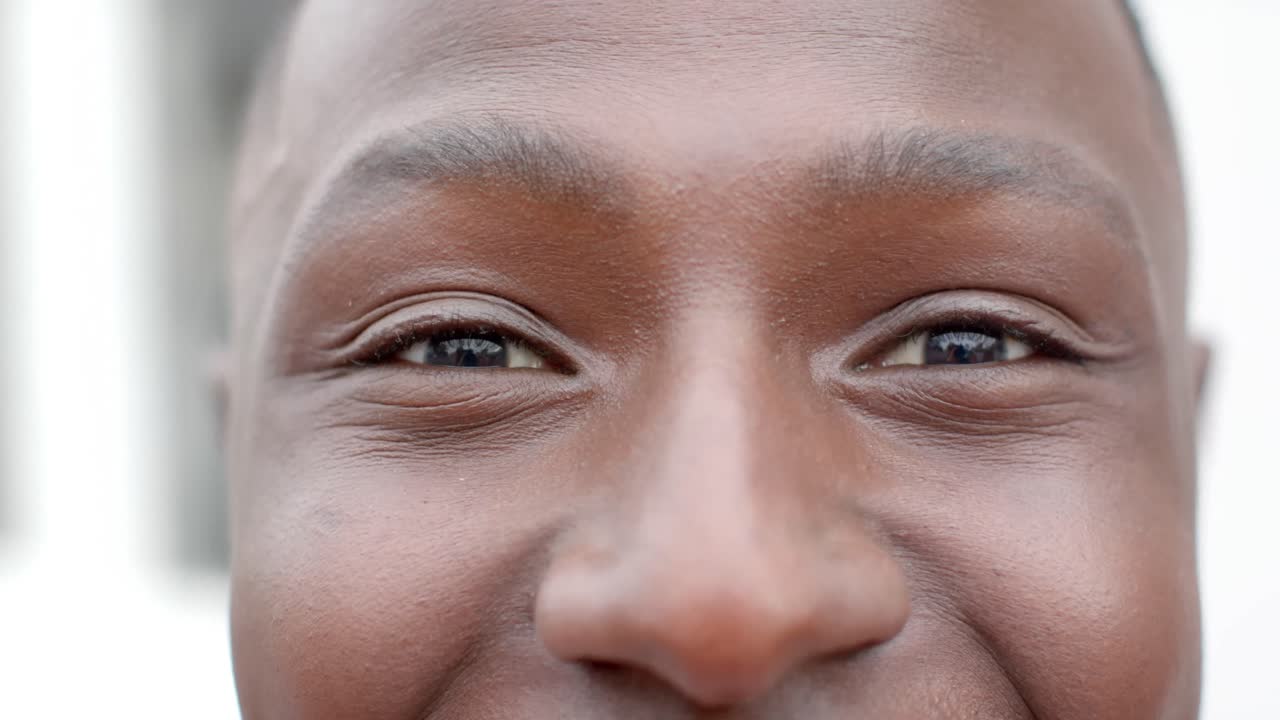 Ritratto di uomo afroamericano felice che guarda in camera a casa, al rallentatore