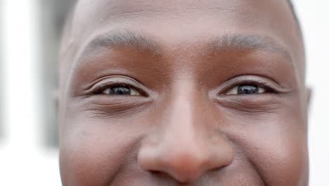 portrait of happy african american man looking at camera at home, slow motion