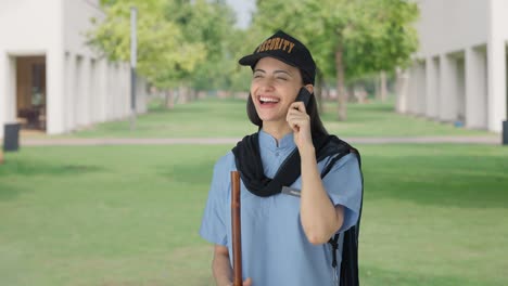 Happy-Indian-female-security-guard-talking-to-someone-on-call