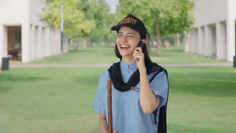 happy indian female security guard talking to someone on call