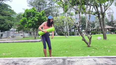 woman practicing yoga in a park