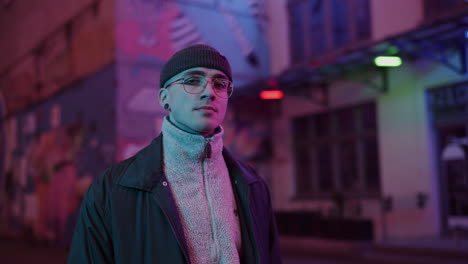 stylish man in neon city at night