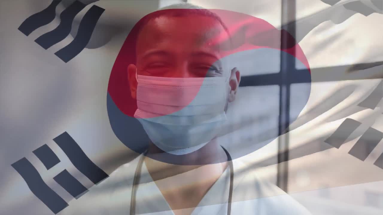 얼굴 마스크를 쓴 미소 짓는 남성 의사와 함께 한국 국기의 애니메이션