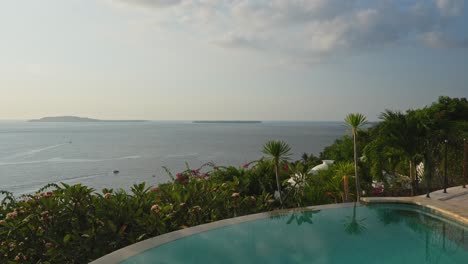 clouds reflecting in private villa infinity pool at sunset on tropical island