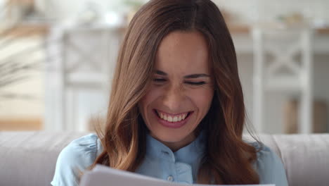 happy business woman looking on financial documents at home office