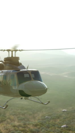 military helicopter flying over desert landscape