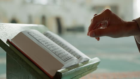 Hands,-Quran-and-closeup-of-woman-reading