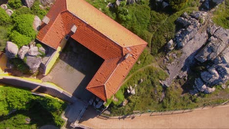 aerial view over pilgrims house of capela de nossa senhora da peninha chapel, in sintra, portugal - orbit, drone shot