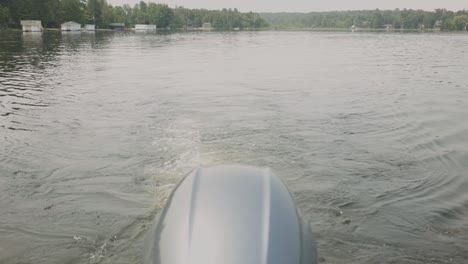 Outboard Motor Of Sailing Boat With Traces On A Tranquil Lake
