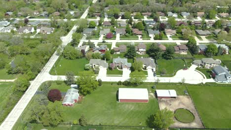 A-vertical-downward-moving-tilt-ending-right-above-three-modern-suburb-styled-family-homes