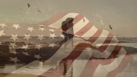 animation of flag of usa over african american couple at beach